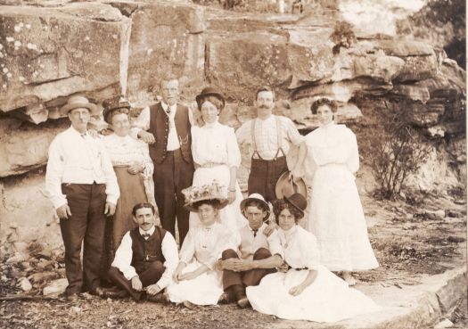 Group of five men and five men women in front of a rock feature