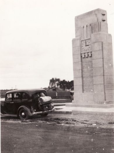Explorers memorial at Penrith NSW. The memorial has a clock face. A car is parked in front.