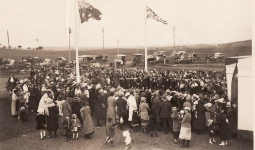 Telopea Park School opening showing a crowd of people with cars in the background.