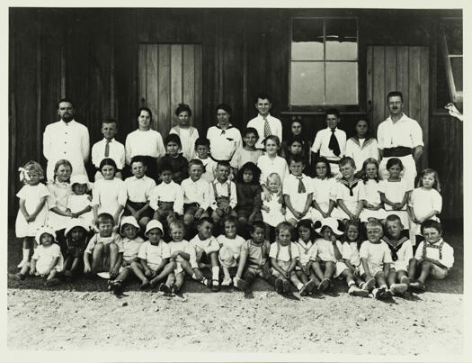 School children at Molonglo internees camp, now Fyshwick. There are about 40 children and two adults in the photo.