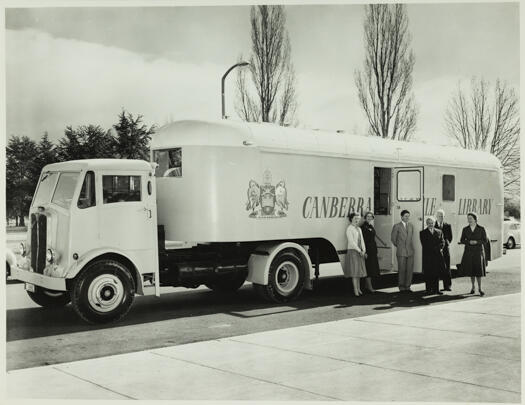 Semi trailer outfitted as a mobile library. Left to right: Miss Pat Andrews (assistant librarian), Mrs Pat Butler (assistant librarian), Mr S. Davies (librarian in charge), Mr. H.L. White (Commonwealth Librarian), Mr J.N. Wilson (driver of the mobile library), Miss Dulcie Penfold (chief extension officer, National Library).