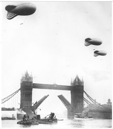 Wartime London showing London Bridge and blimps over the River Thames