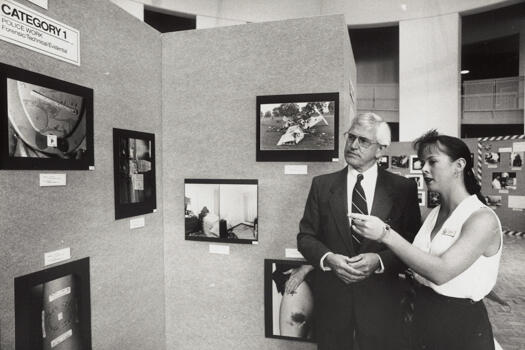 Jim Allen, AFP, and Vanessa Scott looking at an exhibition of photographs