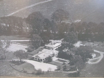 Aerial photograph of Kambah homestead 1960 (framed) including its swimming pool and tennis court. The property Kambah, was owned by Sim and Judy Bennet from 1930 to 1971. The land was resumed by the Government for development and the homestead was later demolished.