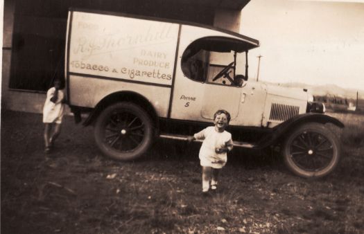 R J Thornhill's shop and van; two unidentified children in photograph standing near the van.