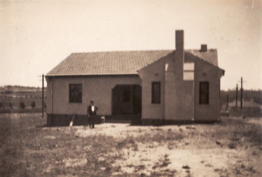 Typical Federal Capital Commission cottage with unidentified man in front. FCT Type 10 reversed.