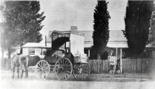 Ainslie Post Office. Shows a four wheeled buggy parked in front with two small children standing in the gateway.