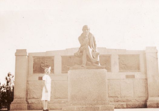 Small girl looking at the statue of Robert Burns in Forrest