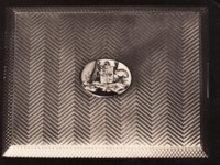 Cigarette case presented to Bert Hinkler by the Commonwealth Government. The case has the Australian Coat of Arms on the front.
