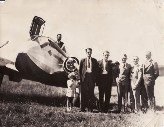 Departure of international swimmers from Canberra. Pilot of monospar twin areoplane Lesley Nish, J.A. Nish, Tares (French swimming champion), John Davies (chemist), M. Poussard (French diving champion), Andrew 'Boy' Charlton (Australian champion).