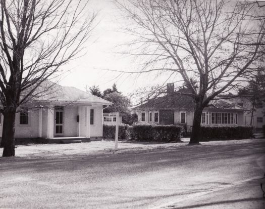 This small cottage, probably brick construction, has a sign outside pointing to Dental Clinic. The location is unknown.