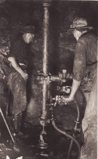 Men working in sewer tunnel