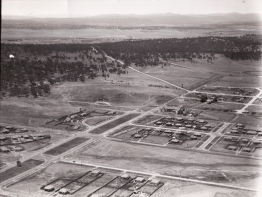 Aerial view looking south east from near Haig Park over Braddon to the War Memorial site. Shows Alt Crescent in Ainslie, the old Yass Road and Hotel Ainslie.