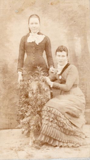 Portrait of Gertrude Ginn (standing) and her sister Agnes Ginn (sitting)