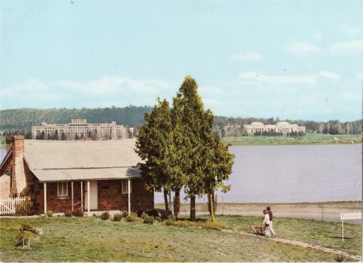 Blundell's Cottage from Wendouree Drive with Lake Burley Griffin, Parliament House and the Administration Building in the background.
