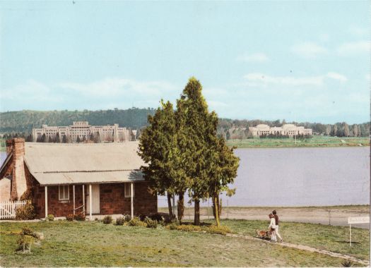 Blundell's Cottage from Wendouree Drive with Lake Burley Griffin, Parliament House and the Administration Building in the background.
