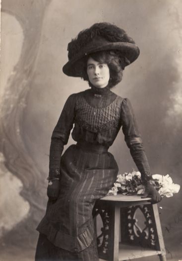 Portrait of Elizabeth Flynn probably before her marriage in 1917. She is dressed in dark clothes, gloves and hat.