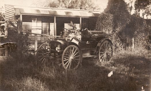 Woman and small child in vintage car