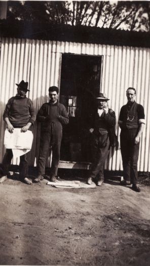 Workmen outside shed
