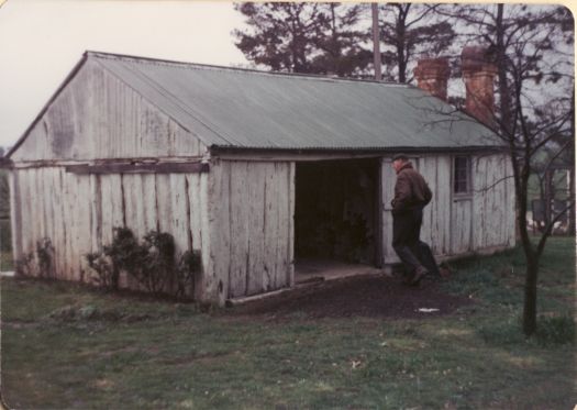 John Garran entering historic hut at Erindale