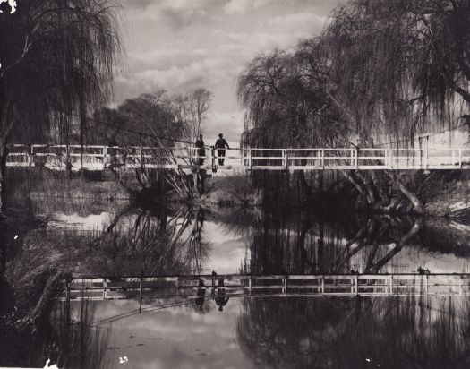 Two men standing on the footbridge over the Molonglo River, Royal Canberra Golf Links