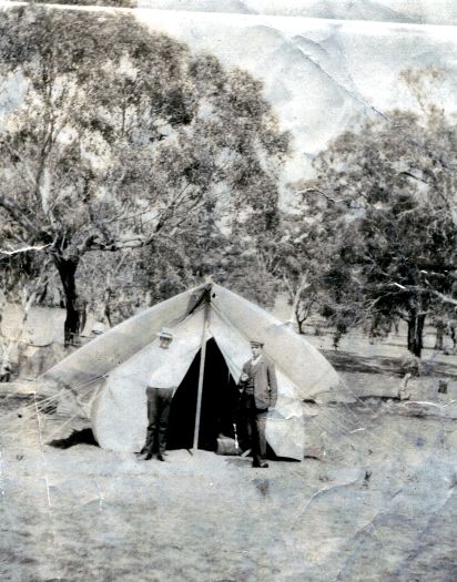 Two men standing in front of a tent on what is believed to be Camp Hill (the site of old Parliament House).