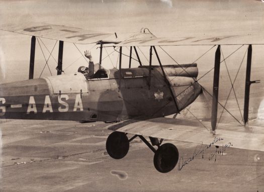 Oscar Garden flying his bi-plane G-AASA, Kia Ora