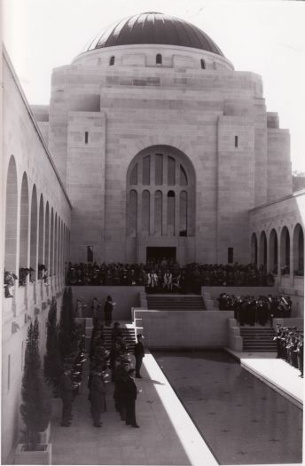 A ceremony (probably Anzac Day Ceremony) near the Pool of Remembrance at the Australian War Memorial. The band of the Royal Australian Air Force is pictured in the right foreground.