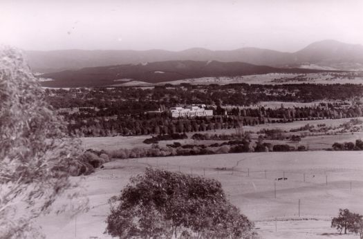 View over river flats to Parliament House