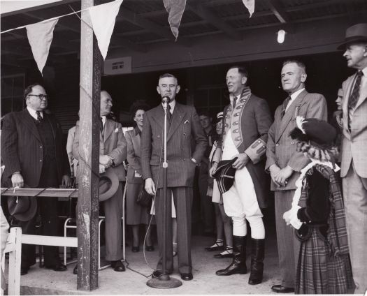 Highland gathering at Manuka Oval. Charles Daley at the microphone.