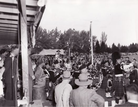 Highland gathering at Manuka Oval, pipe band marching past
Department of Interior