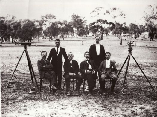Surveying staff. Left to Right: F.J. Broinowski, J. Morgan, A. Percival, C. Scrivener, W. Chapman, P. Sheaffe (with theodolites). 