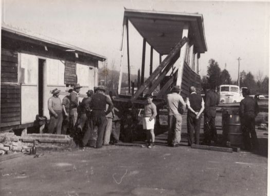 Russian Orthodox Church - group of men and boy watching part of prefab being lifted. Sebille Transport truck at rear.