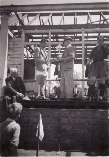 J. Colwell presents cup to winning captain 