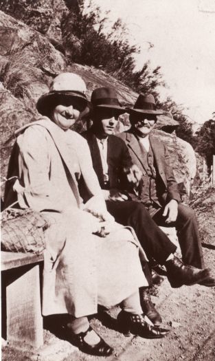 Mr. and Mrs. Ben Naveau and son William sitting on a bench