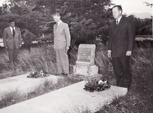 Three men standing by the graves of William and Nina (nee De Salis) Farrer on Lambrigg Hill. 