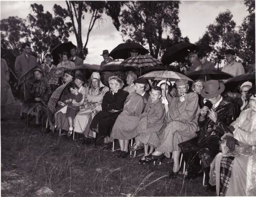 Group of people on a rainy day at the CDHS ceremony at Lambrigg to mark the 50th anniversary of William Farrer's death on 16 April 1906.