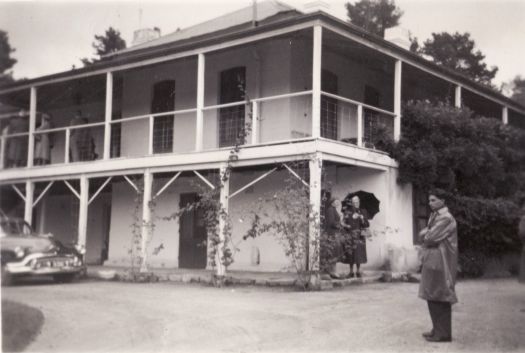 Lambrigg Homestead with 3 women and a man on a rainy day