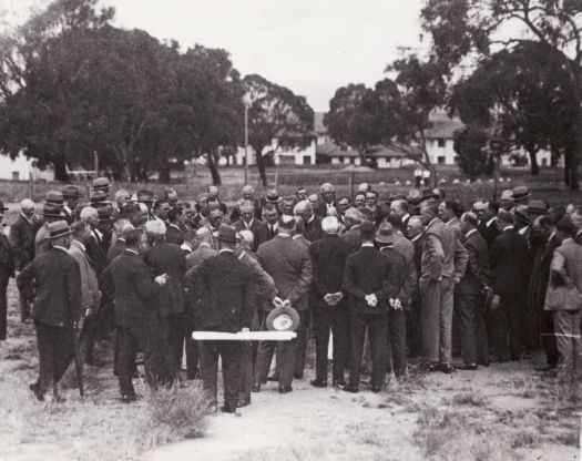 Large gathering of men near Hotel Acton