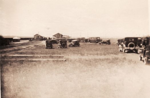 Unidentified railway station and cars