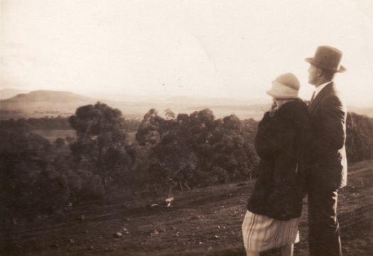 Man and woman looking over a valley dressed in clothes from the 1920s