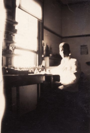 Eric Harvey, dentist at Manuka sitting at his desk