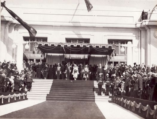 Singing the national anthem on the steps of Parliament House. Dame Nellie Melba by microphone - she sang the national anthem at the ceremony.