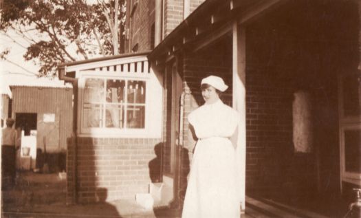 Nurse standing in front of verandah
