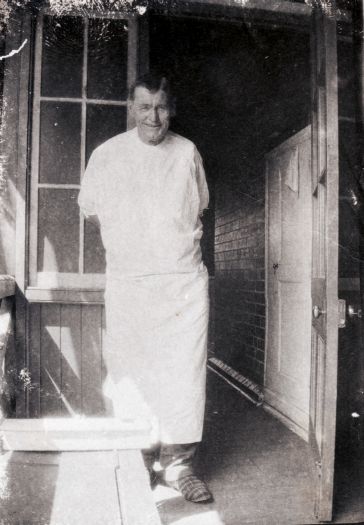 Man, possibly a patient, standing near a doorway