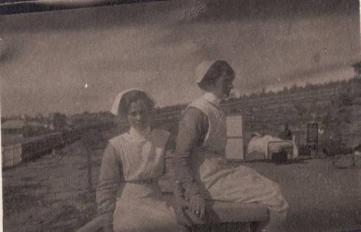 Two nurses sitting outside