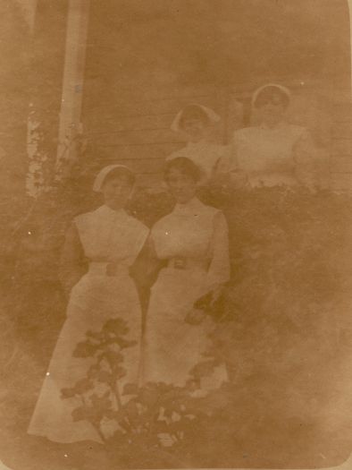 Four nurses standing outside verandah