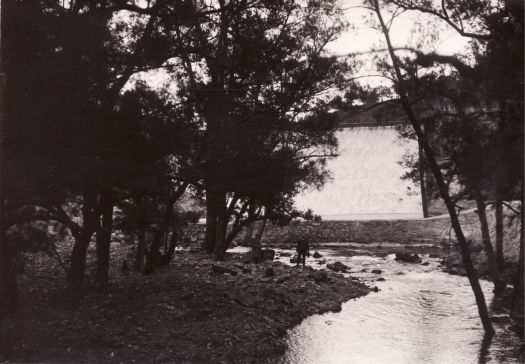 Cotter spillway from the Cotter River with man standing on the bank