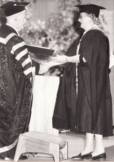 Honorary MA degree being received by Mrs Nan Phillips from Sir John Crawford at the ANU.