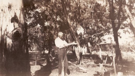 Fisherman showing fish caught in Edwards River